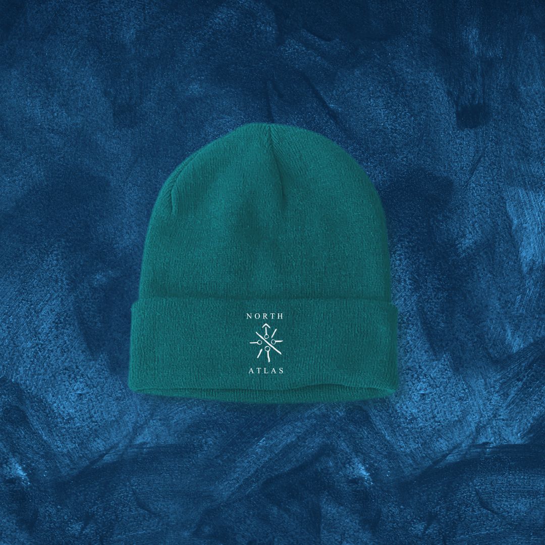 Emerald green beanie with North Atlas Hypnotist Rune logo